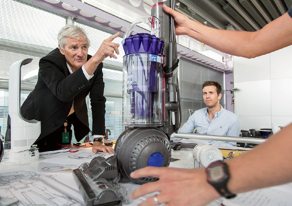 Dyson examines a prototype of the DC41 Animal vacuum cleaner with a team of his engineers. He has a famously young workforce cherry-picked straight from school.